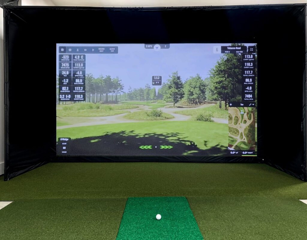 A Carl's Place 16:9 enclosure with GSPro on the impact screen in a simulator room