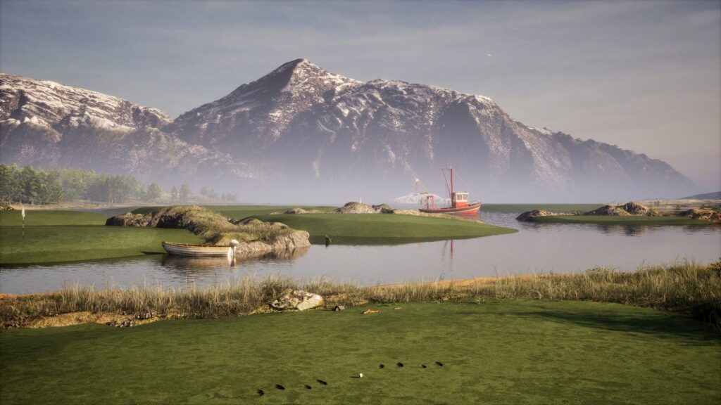 The Infinite Tees practice facility: island greens in a lake below a snowy mountain, with a fishing boat and a rowing boat
