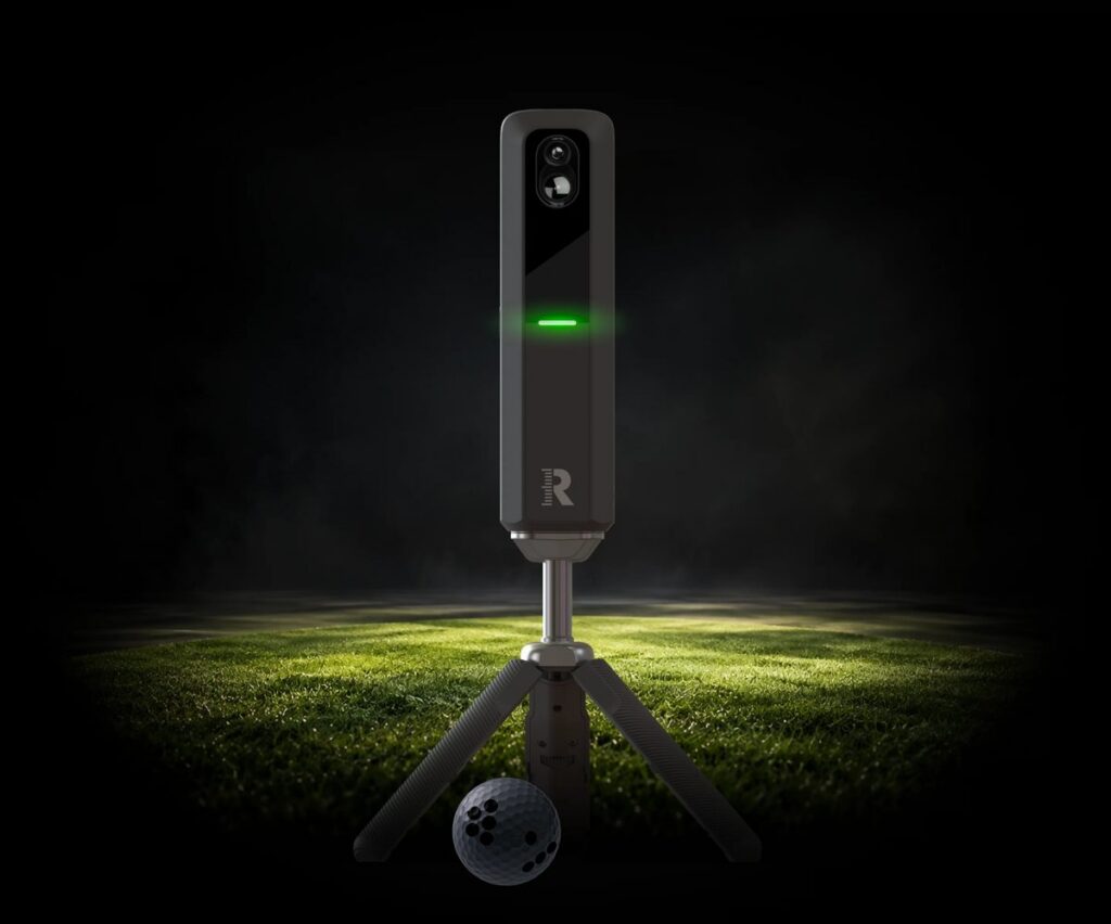 Rapsodo MLM2XPRO launch monitor on its tripod behind a golf ball